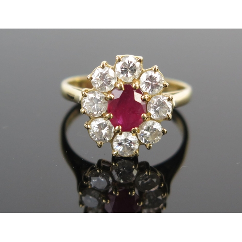 14 - A Modern 18ct Gold, Ruby and Diamond Cluster Ring, 14x13mm head, ruby c. 6.5x5.1mm, c. 3.5mm brillia... 