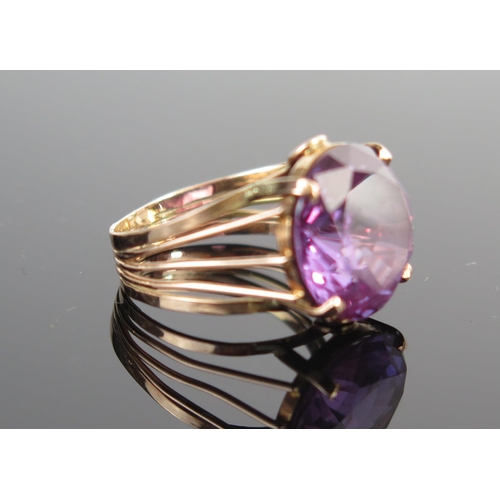 140 - A 9ct Gold and Purple Stone Dress Ring, 14mm head, size L.5, 5g