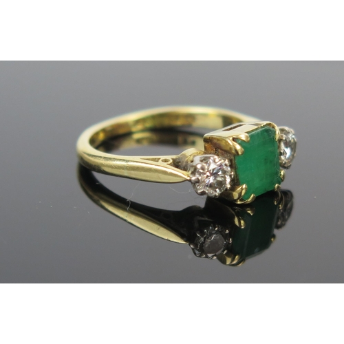 15 - A Modern 18ct Gold, Emerald and Diamond Three Stone Ring,  c. 6.9x5.8mm emerald and 4mm brilliant ro... 