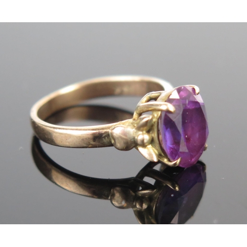 198 - A 14K Gold and Purple Stone Dress Ring, 10x8mm stone, size J.75, 3.3g. Possibly purple topaz.