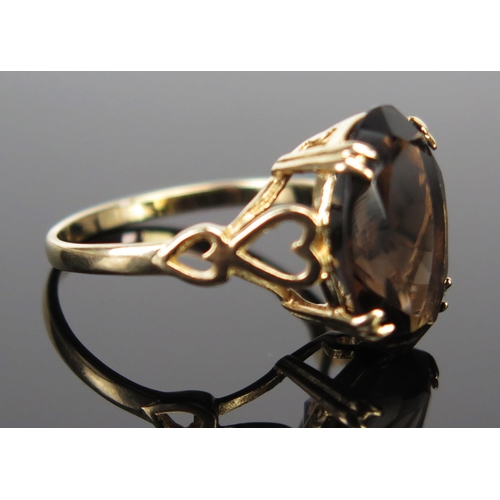 209 - A 9ct Gold and Smoky Quartz Dress Ring, the 14x10mm stone in a claw setting, full Birmingham hallmar... 