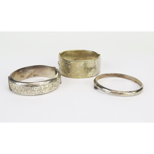 232 - A Chester Silver Hinged Bangle with chased scrolling foliate decoration (18mm wide, 1957, S&E) and o... 