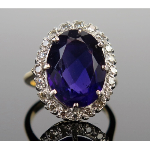 60 - An 18ct Gold, Amethyst and Diamond Cluster Ring, 16x12mm central stone surrounded by c. 2mm diamonds... 