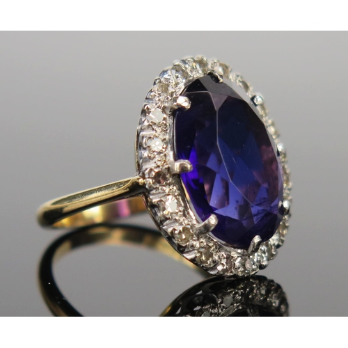 60 - An 18ct Gold, Amethyst and Diamond Cluster Ring, 16x12mm central stone surrounded by c. 2mm diamonds... 