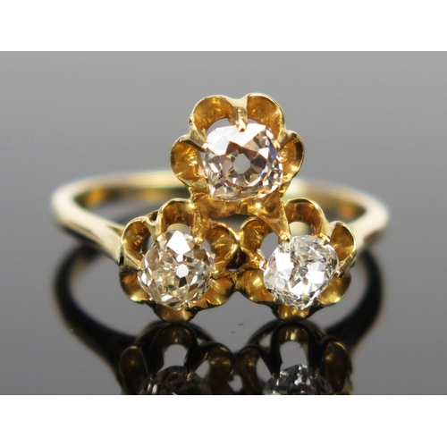 63 - An Old Cut Diamond Three Stone Ring in an unmarked high carat gold setting, size M.25, 3.2g