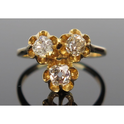 63 - An Old Cut Diamond Three Stone Ring in an unmarked high carat gold setting, size M.25, 3.2g