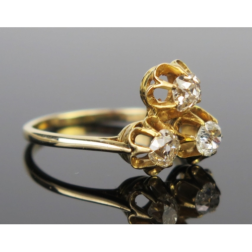 63 - An Old Cut Diamond Three Stone Ring in an unmarked high carat gold setting, size M.25, 3.2g