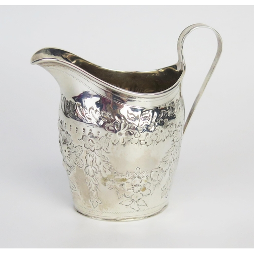 712 - A George III silver cream jug, maker's mark worn, London, 1800, of barge-shaped outline with repouss... 