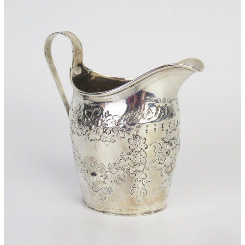 712 - A George III silver cream jug, maker's mark worn, London, 1800, of barge-shaped outline with repouss... 