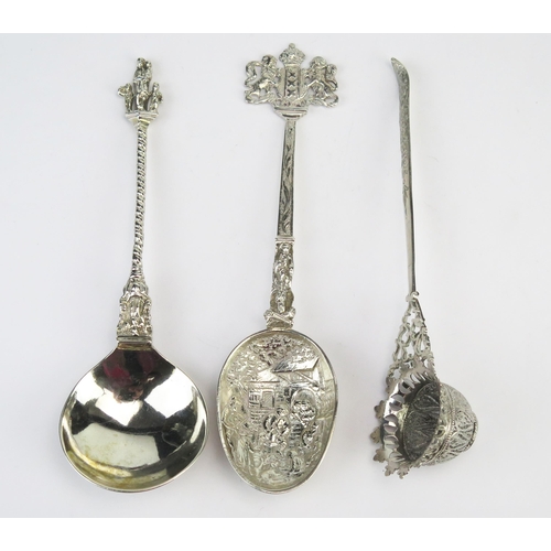 744 - A continental silver spoon, stamped marks, with pear-shaped bowl on spiral twist stem and figural te... 