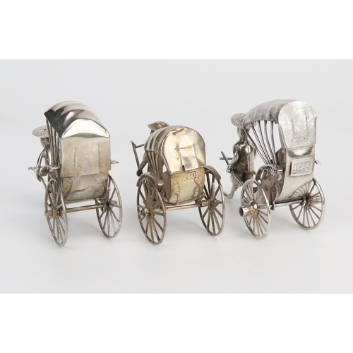 760 - Three oriental silver models of rickshaws, one with passenger, 9cm and 7cm long, total weight of sil... 