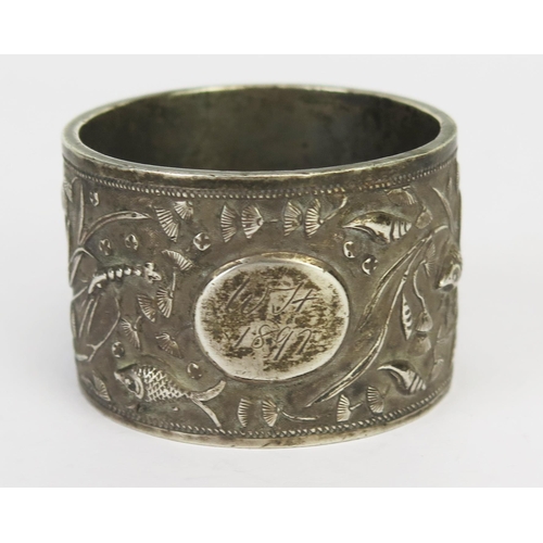 775 - A Chinese silver napkin ring, maker Luen Hing, Shanghai, initialled, decorated with shells and fish,... 