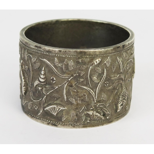 775 - A Chinese silver napkin ring, maker Luen Hing, Shanghai, initialled, decorated with shells and fish,... 