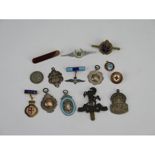 778 - A collection of assorted silver and other sporting badges, Arm cap badge, RAF sweetheart brooch and ... 