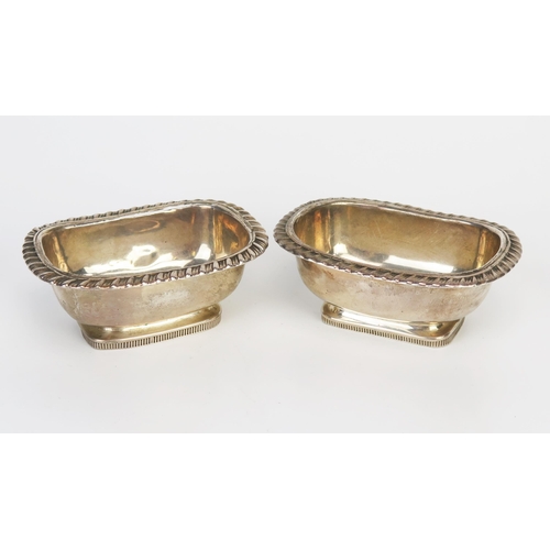 787 - Two near matching rectangular silver salts, marks worn and rubbed, with gadrooned borders and raised... 