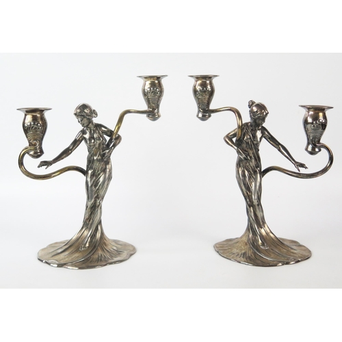 WMF, a pair of Jugendstil silver plated figural twin branch candelabra, the sconces on sinuous swept branches supported by semi naked female dressed in robes, model No's 269 and 269A, raised and impressed marks, 28cm high (2)