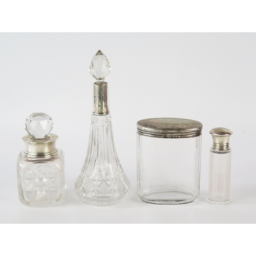 798G - Four clear glass and silver mounted dressing table jars and scent bottles, various makers and dates.