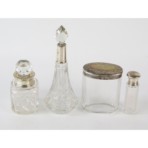 798G - Four clear glass and silver mounted dressing table jars and scent bottles, various makers and dates.