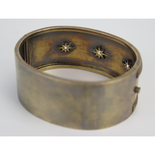 89 - A Victorian Gilt Metal and Old Cut Diamond Hinged Bangle, set with 3 c. 3mm stones, 32.3g