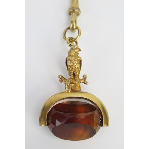 90 - A 19th Century Citrine Swivel Seal with eagle finial in a yellow metal mount and on a gilt chain wit... 