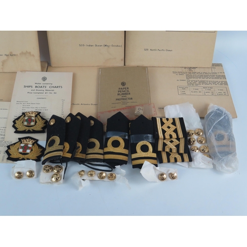 911 - A collection of naval officers epaulettes, cap badges, buttons, together with naval charts for the N... 