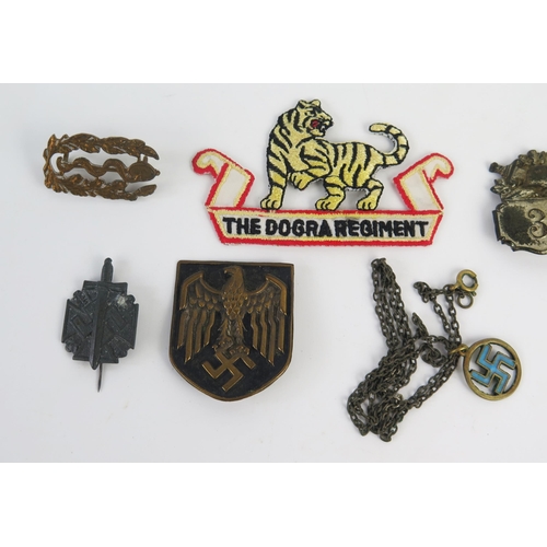 938 - A Third Reich period pressed metal badge with National Emblem, other assorted badges and pendant