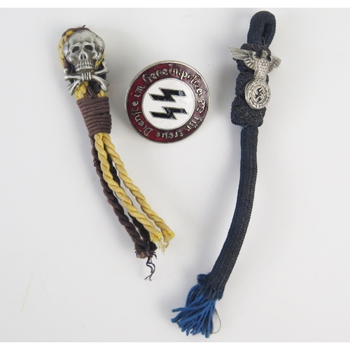 939 - A replica SS police enamel badge, and two woven part hangers with totenkopf badge and another with n... 