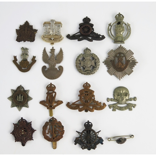 946 - A collection of British regimental cap badges, includes Royal Scots Guards, Royal Artillery, Devonsh... 