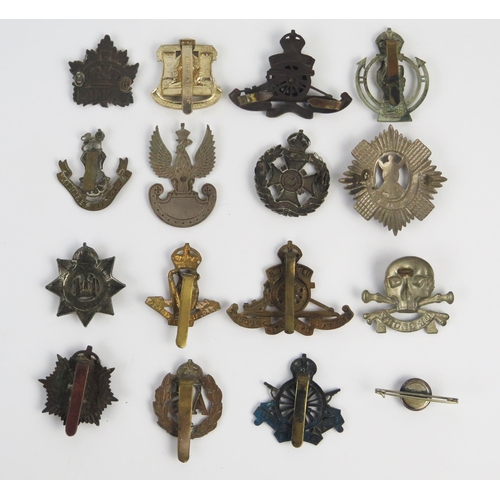 946 - A collection of British regimental cap badges, includes Royal Scots Guards, Royal Artillery, Devonsh... 