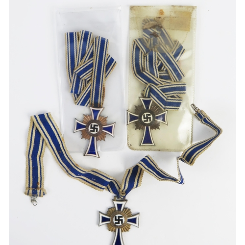 955 - Three Third Reich period Mothers Crosses, includes one bronze and two gold coloured examples, with r... 