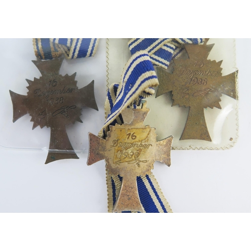 955 - Three Third Reich period Mothers Crosses, includes one bronze and two gold coloured examples, with r... 