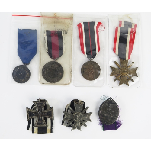 957 - A World War One Imperial German Iron Cross 2nd class, a Third Reich War Merit Cross 2nd Class with s... 