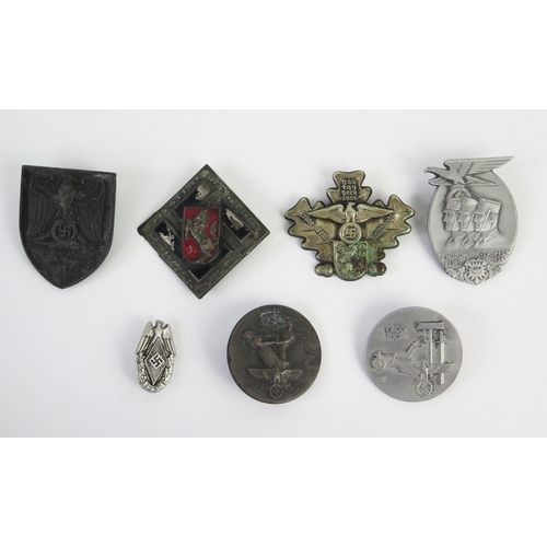 958 - A Third Reich period Nordmark-Treffen 1936 badge, together with six other assorted badges and tinnie... 