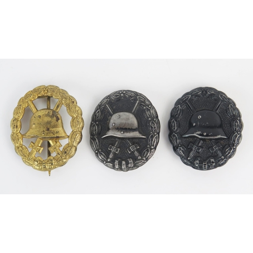 973 - Three World War One Imperial German wound badges, includes black, silver and gold variants. (3)