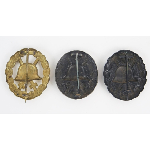 973 - Three World War One Imperial German wound badges, includes black, silver and gold variants. (3)