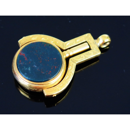 59 - An Antique Gold Swivel Watch Key set with carnelian and bloodstone and with chased decoration, c. 51... 