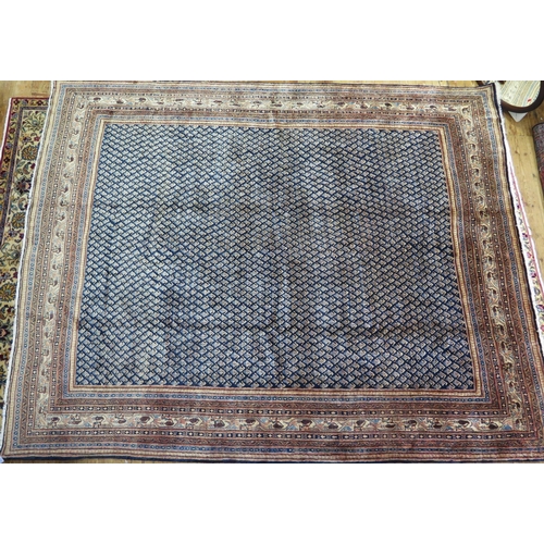 1350 - An Arak rug the central field with all over boteh motifs to a blue ground, enclosed within a multipl... 