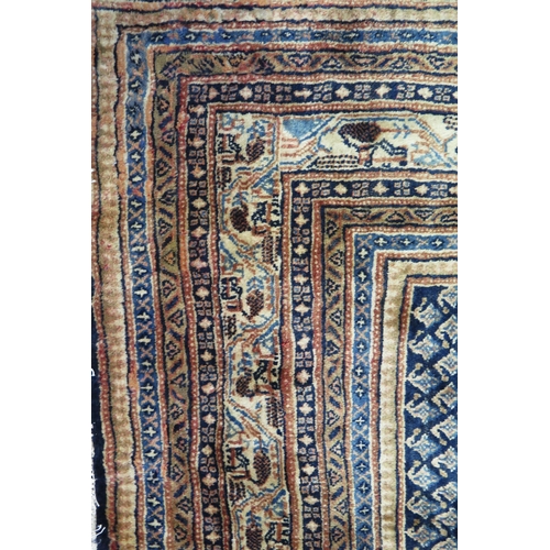 1350 - An Arak rug the central field with all over boteh motifs to a blue ground, enclosed within a multipl... 