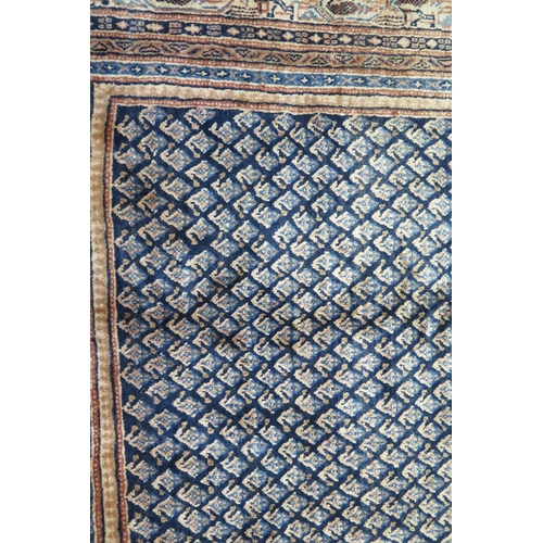 1350 - An Arak rug the central field with all over boteh motifs to a blue ground, enclosed within a multipl... 