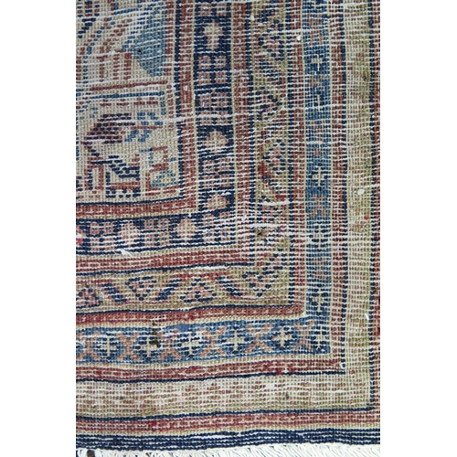 1350 - An Arak rug the central field with all over boteh motifs to a blue ground, enclosed within a multipl... 