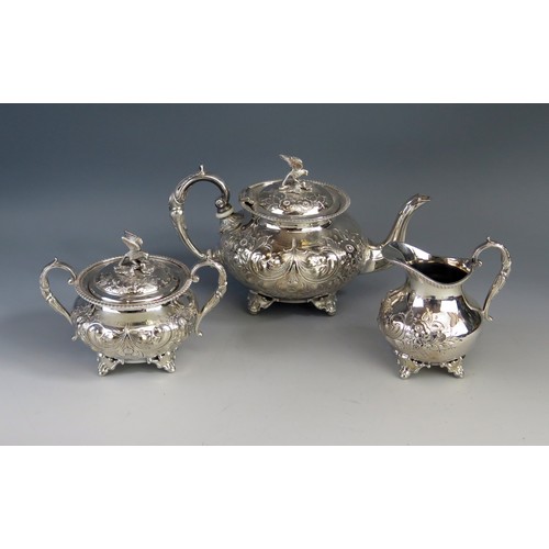 735 - A silver plated three-piece tea service, of squat circular form, with bird finial and floral decorat... 