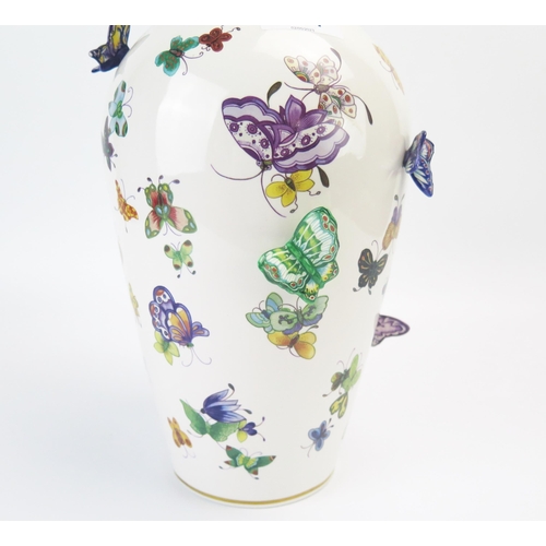 1357 - A Franklin Mint porcelain vase, decorated with painted and applied butterflies, 30cm high.