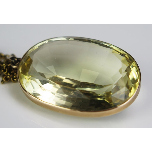 130 - A Large Citrine Pendant in a precious yellow metal surround and on a gilt belcher chain, c. 41x29mm ... 