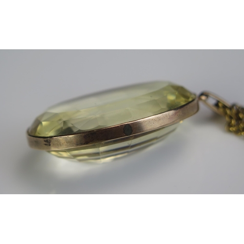 130 - A Large Citrine Pendant in a precious yellow metal surround and on a gilt belcher chain, c. 41x29mm ... 