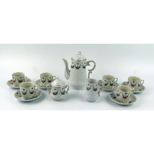 1301 - A late 19th /early 20th century continental nursery tea service, with floral garland decoration, inc... 