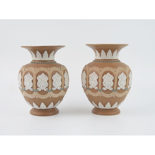 1314 - A pair of Royal Doulton Silicon pottery vases, of ovoid form, with panelled flowerhead decoration, 1... 