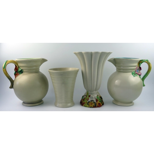 1315 - Clarice Cliff for Newport Pottery, two garden jugs, 23cm high,  a fluted vase with moulded floral ba... 