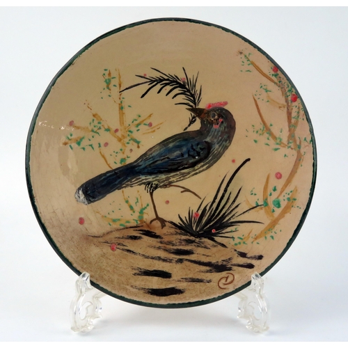 1335 - A Diaz Costa pottery plate, decorated with an exotic bird amongst shrubs, monogrammed CD, 21cm diame... 