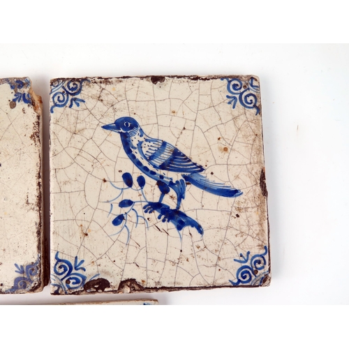 1342 - Three Dutch Delft tiles, each depicting a bird, with ox-head corner motifs, each 13 x 13cm