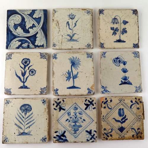 1343 - Nine assorted Dutch Delft tiles each decorated with a flower or floral sprays, each 13 x 13cm.